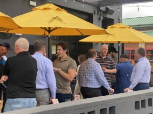 What Now Media Group CEO and Founder Caleb J. Spivak (center) mingles with DFW's building restaurateurs on the expansive Postino Addison patio.